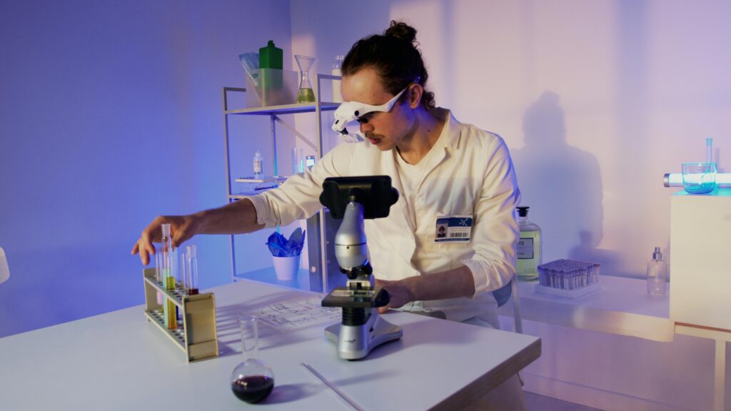 pexels-photo-8533095-8533095 A researcher in a lab coat uses a microscope at a modern laboratory setup.